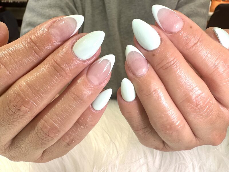 Milky white almond nails with soft pink french accent