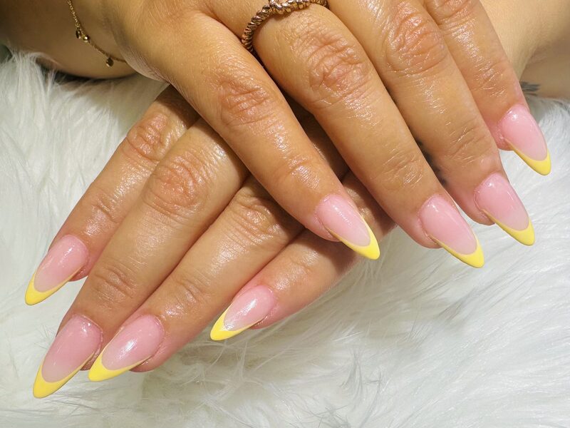 Long stiletto nails with vibrant yellow french tips