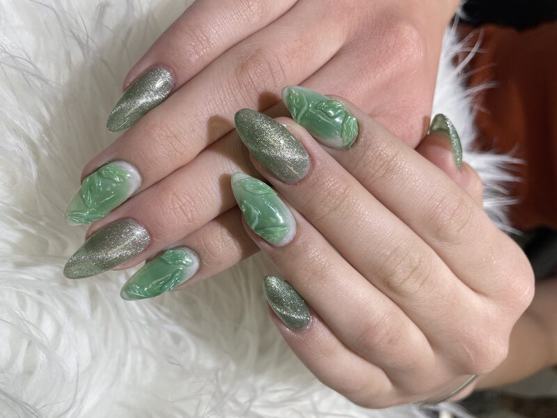 Sage green chrome nails with sculpted leaf art