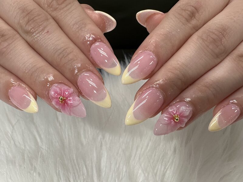 Long burgundy stiletto nails with floral art and gold beading