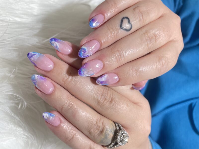 Pink stiletto nails with white and red daisy art