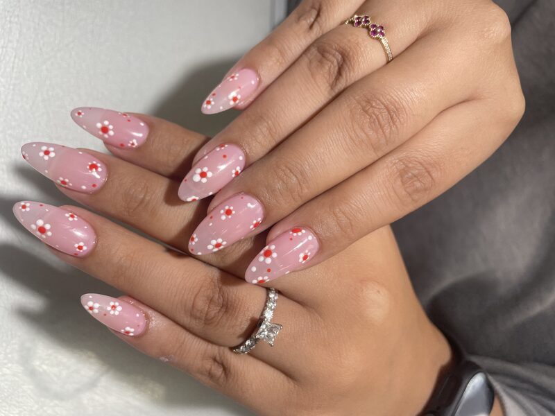 Pink almond nails with red and white daisy florals